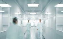 Abstract doctors walking through a hospital.